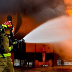 Two firefighters fighting a fire.